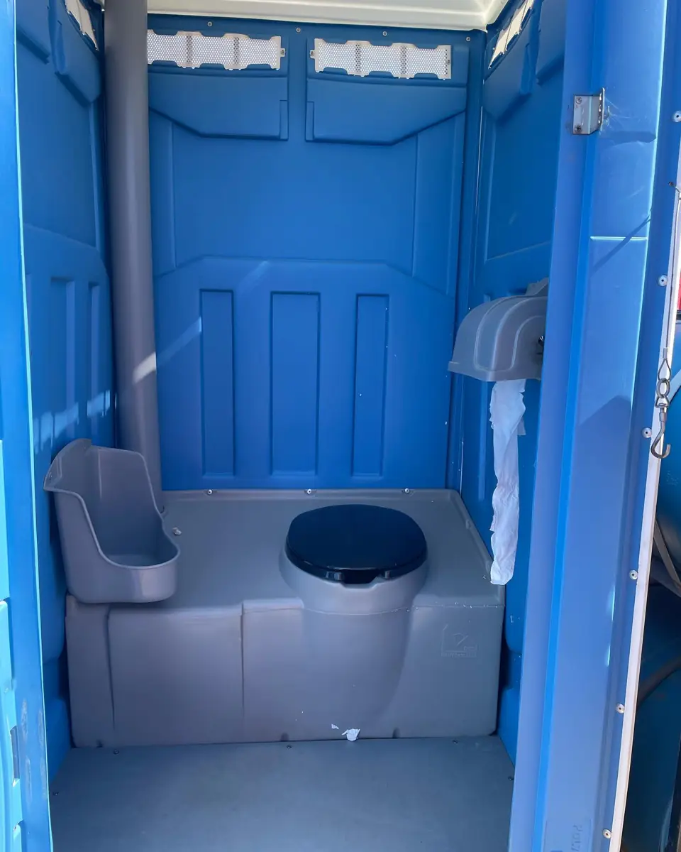 Clean blue porta potty interior after service